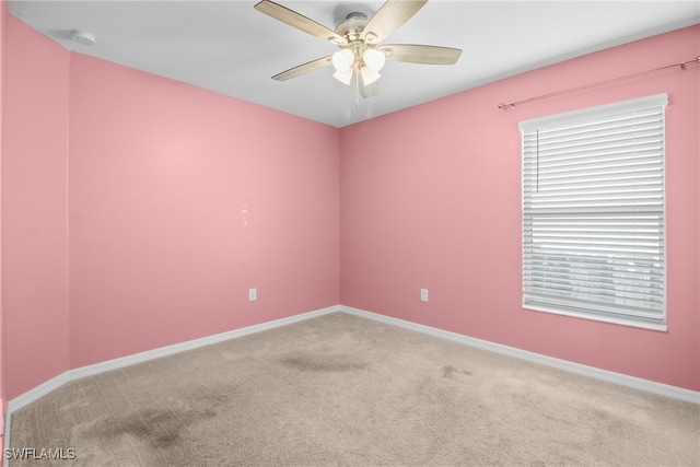 carpeted empty room featuring ceiling fan