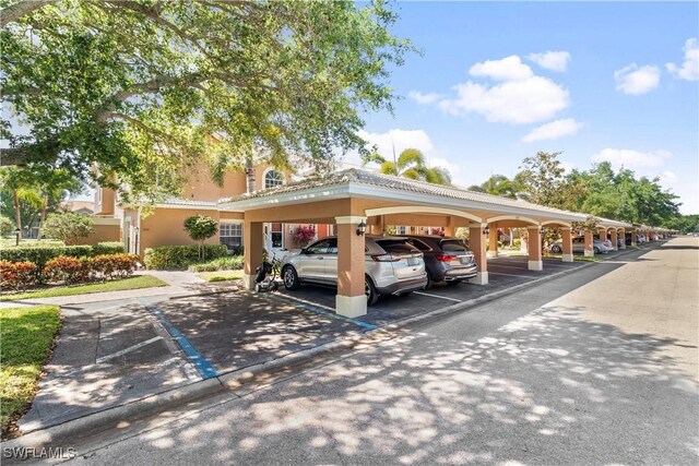 view of vehicle parking featuring a carport