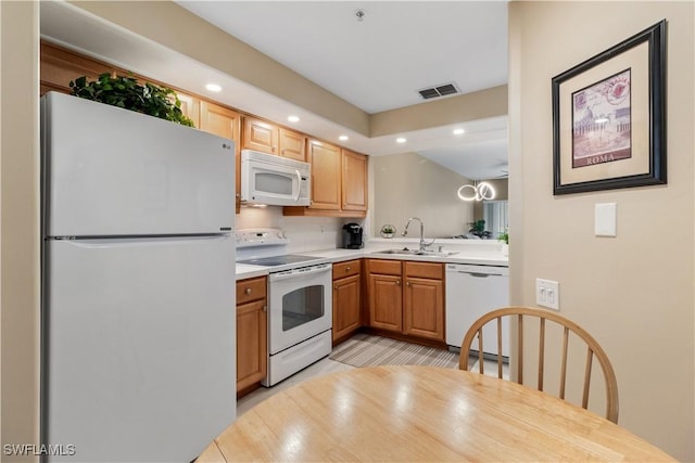 kitchen featuring sink and white appliances