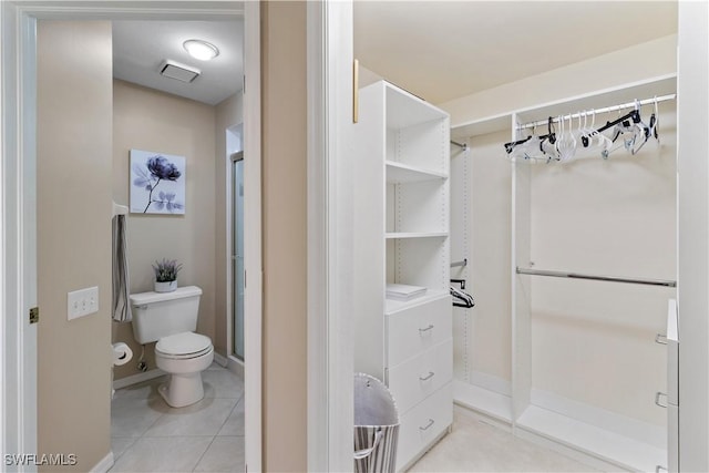 bathroom with tile patterned floors and toilet