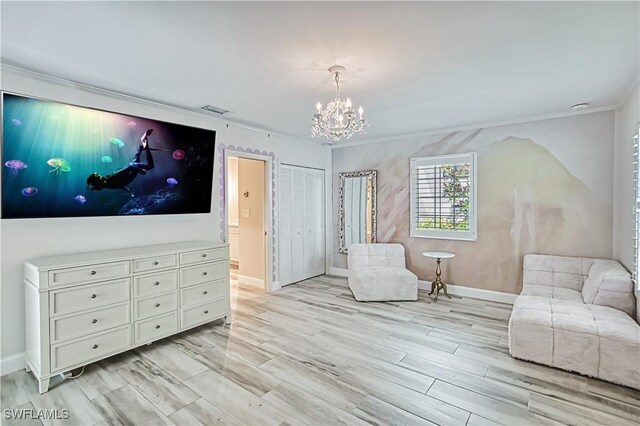 living area with ornamental molding, light hardwood / wood-style floors, and a chandelier