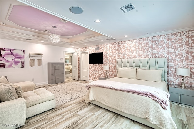 bedroom with a raised ceiling, ornamental molding, an inviting chandelier, and hardwood / wood-style flooring