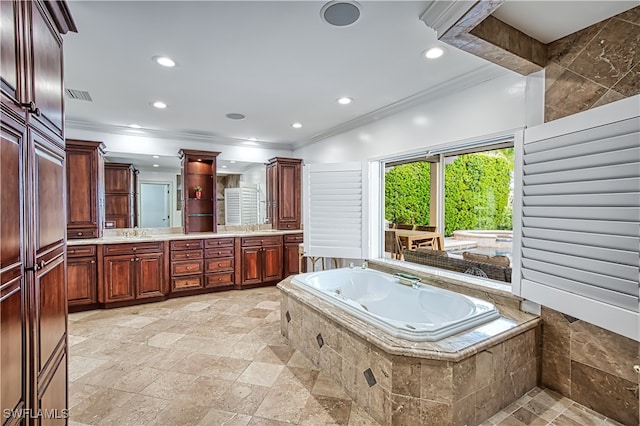 bathroom featuring a relaxing tiled tub, ornamental molding, and vanity