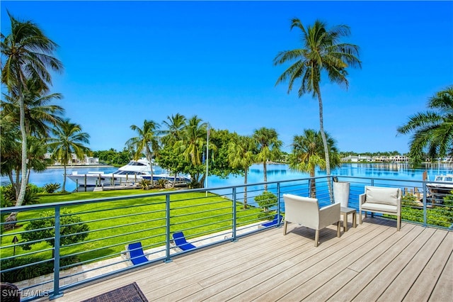 wooden terrace featuring a yard and a water view