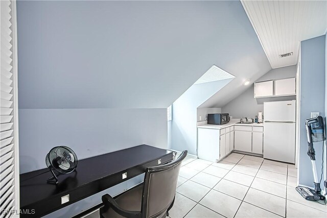 tiled office with lofted ceiling and sink