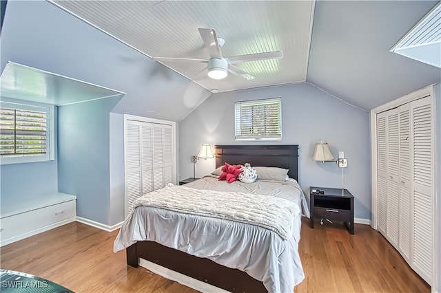 bedroom featuring multiple windows, wood-type flooring, vaulted ceiling, and ceiling fan