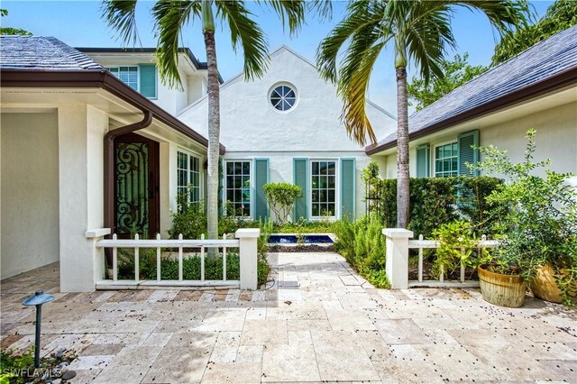 view of exterior entry featuring a patio