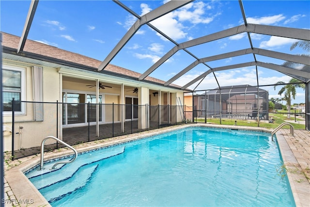 view of pool featuring ceiling fan, a patio, and a lanai