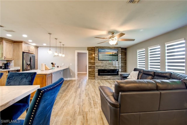 113 SE 41st St, Cape Coral, FL 33904 - living room featuring baseboards, recessed lighting, a fireplace, a ceiling fan, and light wood finished floors