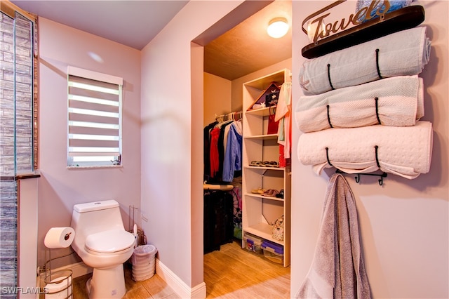 bathroom with hardwood / wood-style flooring and toilet