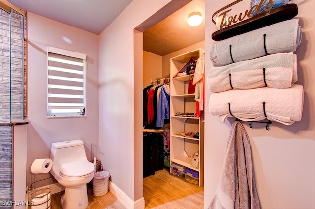 113 SE 41st St, Cape Coral, FL 33904 - bathroom with toilet, wood finished floors, and baseboards