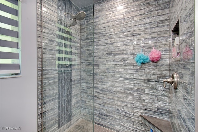 bathroom with tiled shower