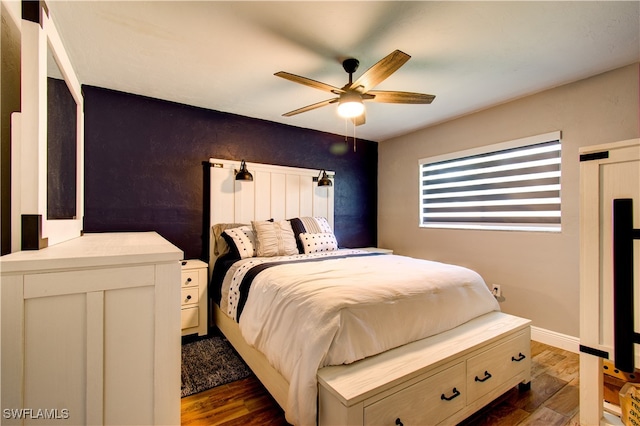 bedroom featuring ceiling fan and dark wood-type flooring