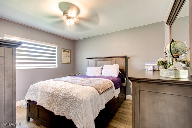 bedroom featuring ceiling fan and dark hardwood / wood-style floors