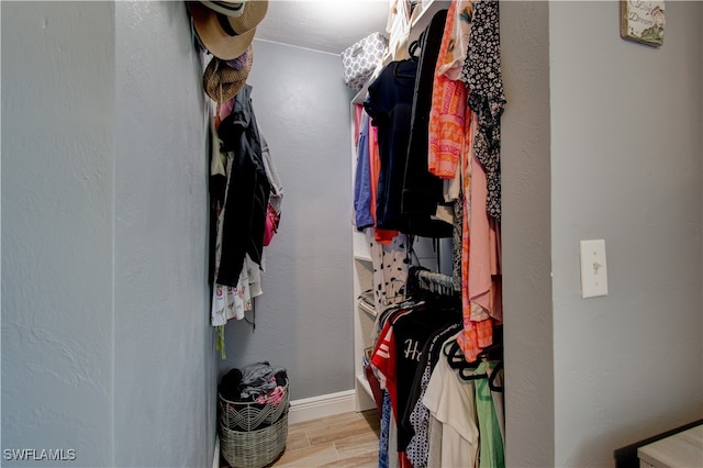 spacious closet with light hardwood / wood-style floors