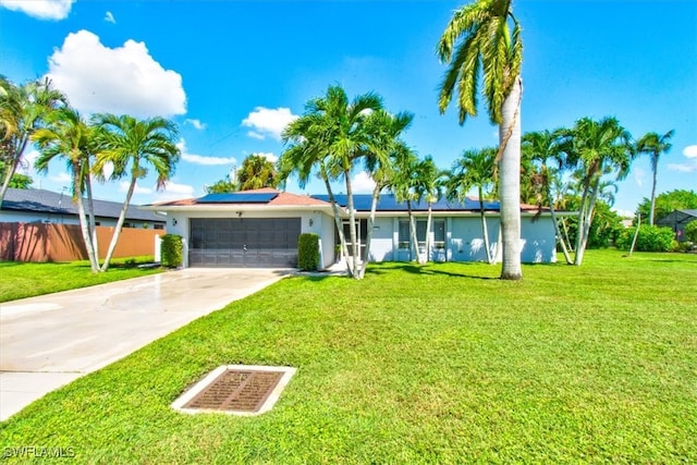 ranch-style home featuring a garage and a front yard