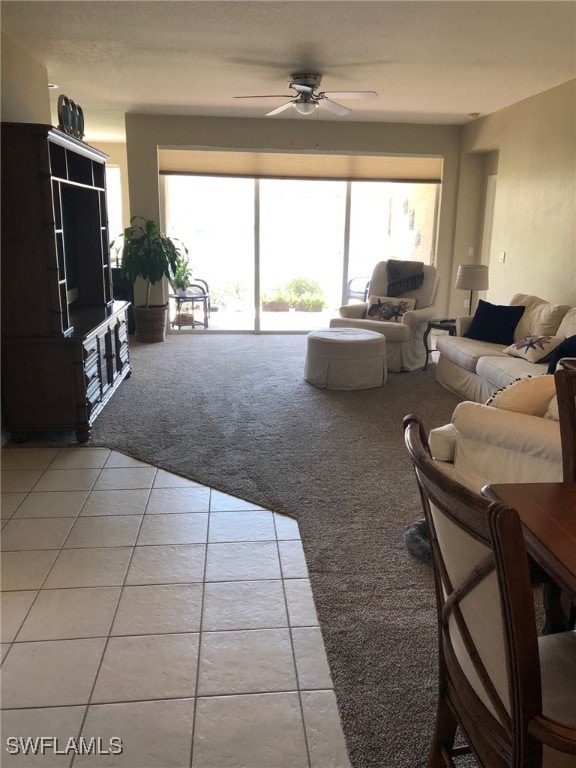 carpeted living room with ceiling fan and a healthy amount of sunlight