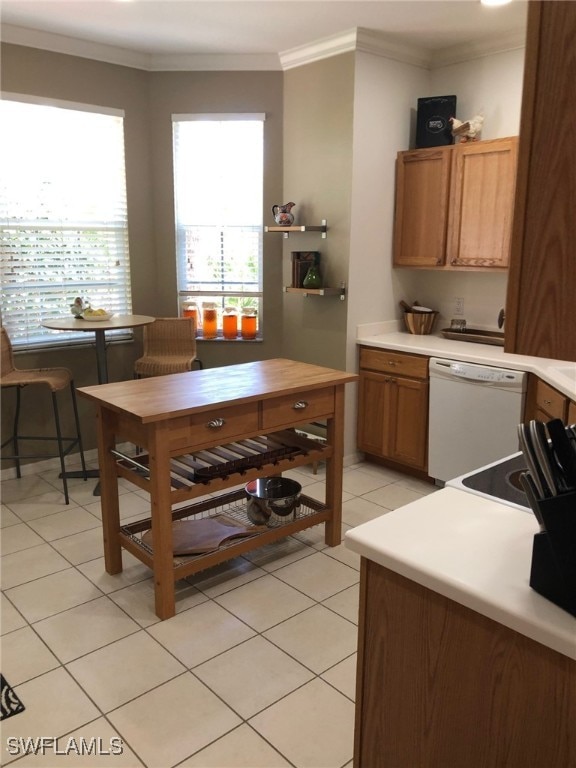 kitchen featuring white dishwasher, crown molding, and light tile patterned floors