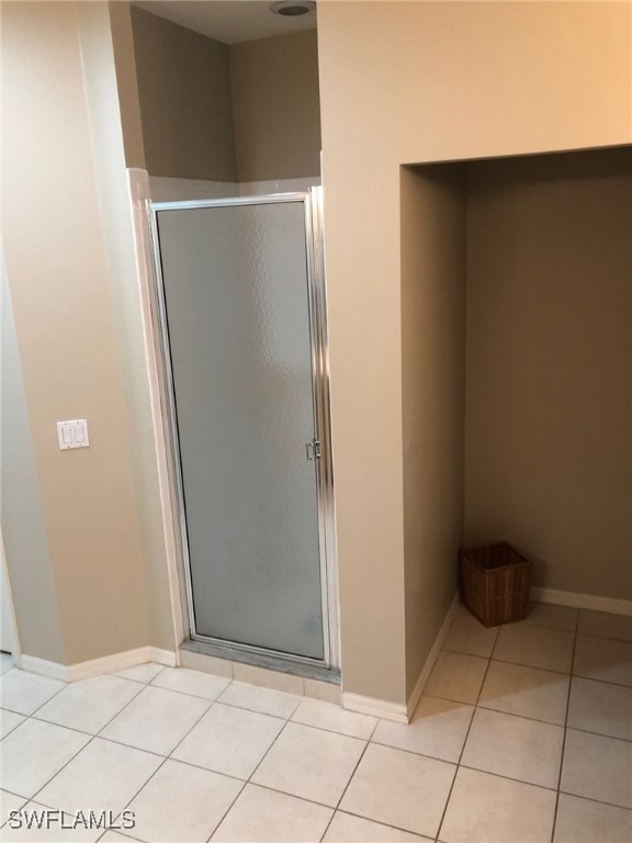 bathroom featuring tile patterned flooring and a shower with door