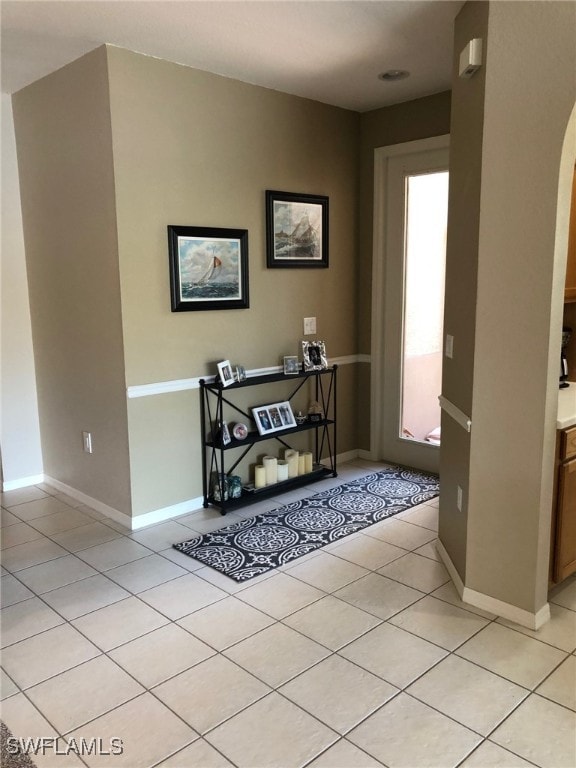 hall with light tile patterned flooring