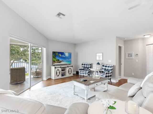 living room featuring ceiling fan and light hardwood / wood-style floors