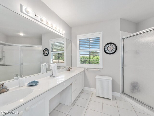 bathroom featuring tile patterned floors, walk in shower, and vanity