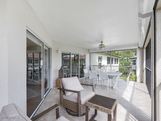 sunroom / solarium featuring ceiling fan