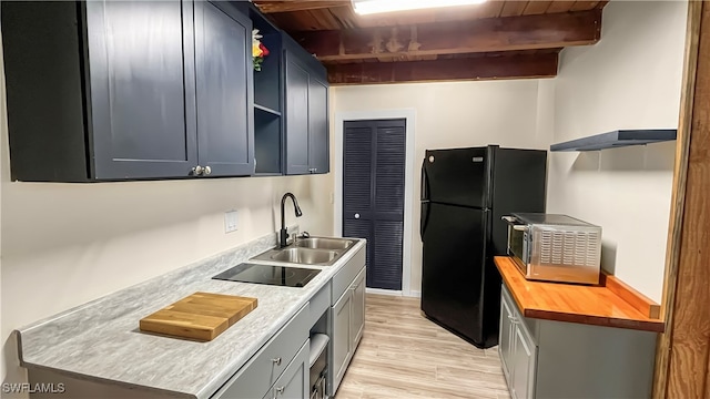 kitchen featuring light hardwood / wood-style floors, beam ceiling, wood ceiling, sink, and black appliances