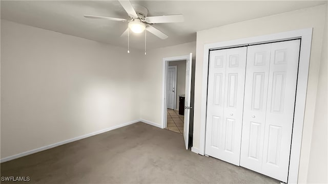 unfurnished bedroom featuring light carpet, ceiling fan, and a closet