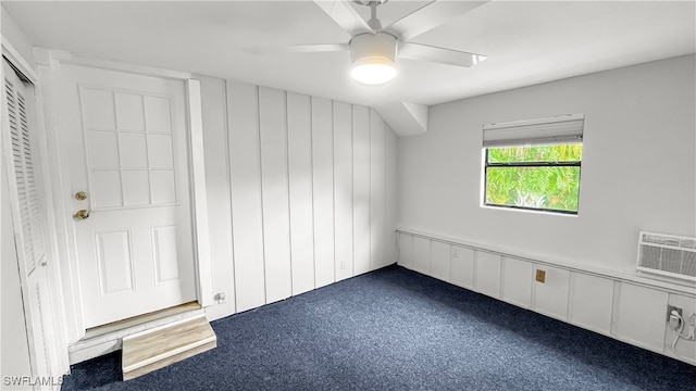 interior space with ceiling fan, a wall mounted AC, and carpet