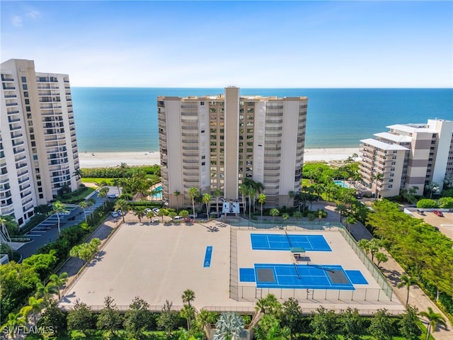 bird's eye view with a water view and a beach view