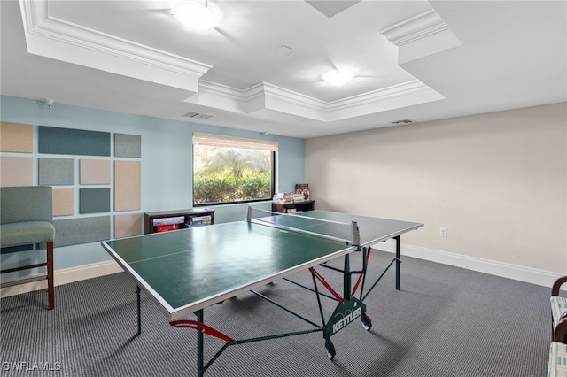 game room with carpet, a tray ceiling, and ornamental molding