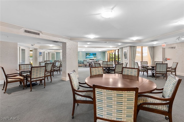 carpeted dining space with crown molding