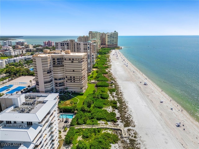 bird's eye view featuring a water view and a beach view