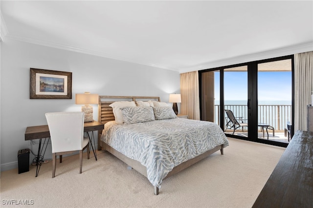 carpeted bedroom featuring a water view, crown molding, access to outside, and a wall of windows