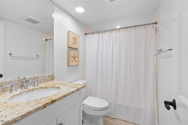 bathroom with toilet, vanity, and a shower with shower curtain