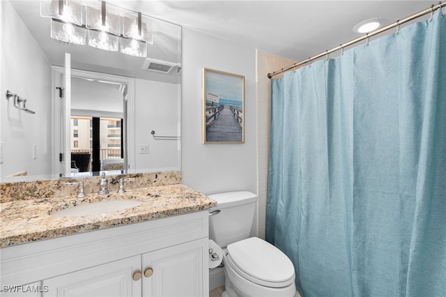 bathroom featuring vanity, toilet, and walk in shower