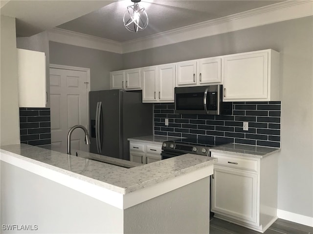 kitchen featuring stainless steel appliances, kitchen peninsula, and white cabinetry