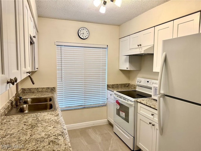 kitchen featuring white cabinets, light stone countertops, white appliances, and a textured ceiling