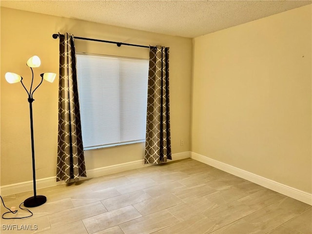 spare room with a textured ceiling