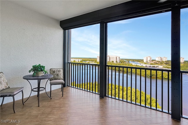 sunroom / solarium featuring a water view