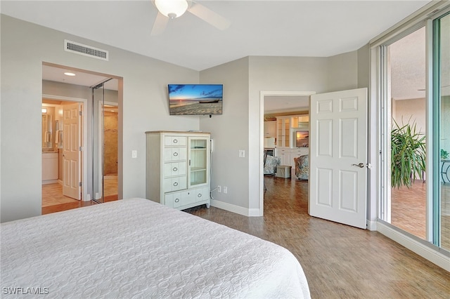 bedroom featuring access to outside, hardwood / wood-style floors, ensuite bath, and ceiling fan