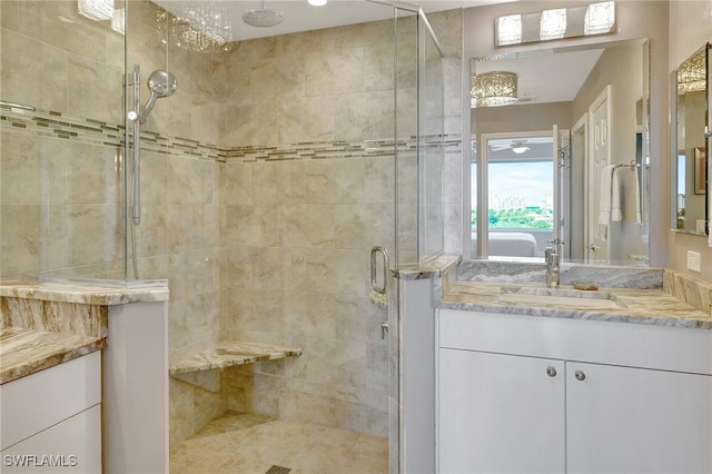 bathroom featuring walk in shower and vanity