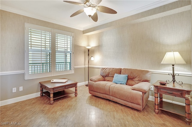 living room with ornamental molding, ceiling fan, and hardwood / wood-style floors