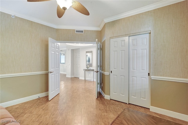 interior space featuring ceiling fan, ornamental molding, and hardwood / wood-style floors