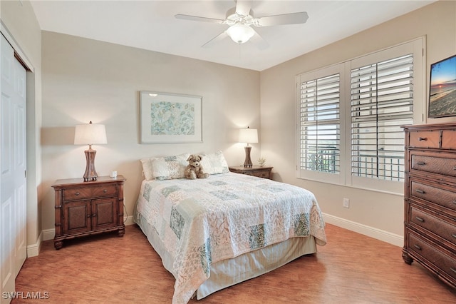 bedroom featuring ceiling fan, a closet, and light wood-type flooring