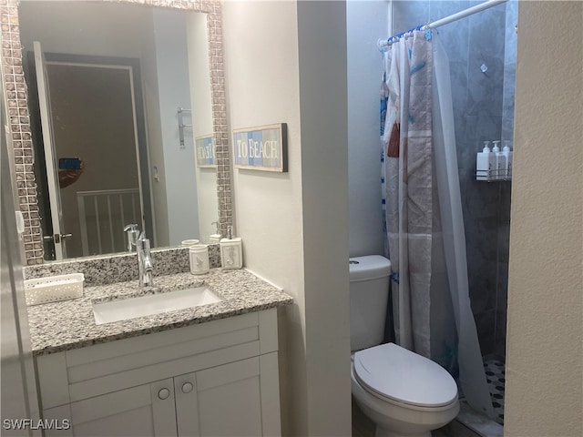 bathroom featuring vanity, toilet, and a shower with shower curtain