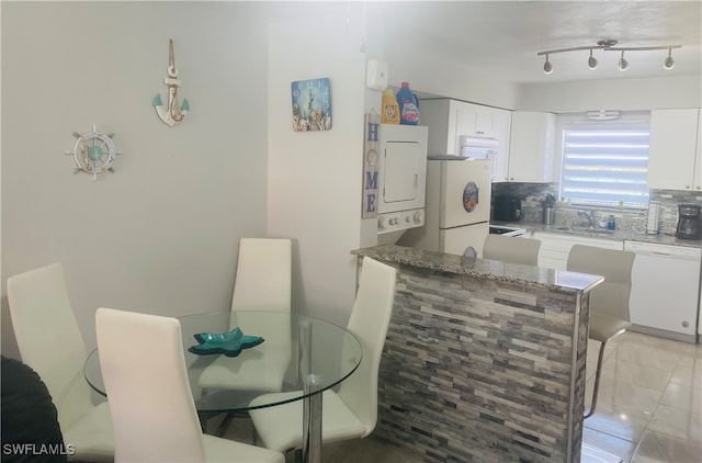 tiled dining space featuring sink