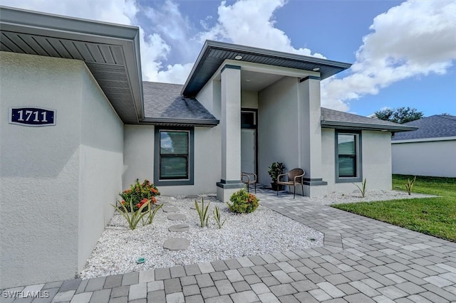 view of exterior entry featuring a patio area