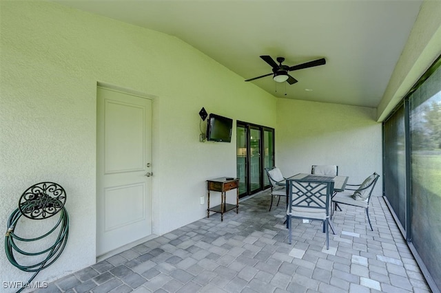 unfurnished sunroom featuring ceiling fan and lofted ceiling